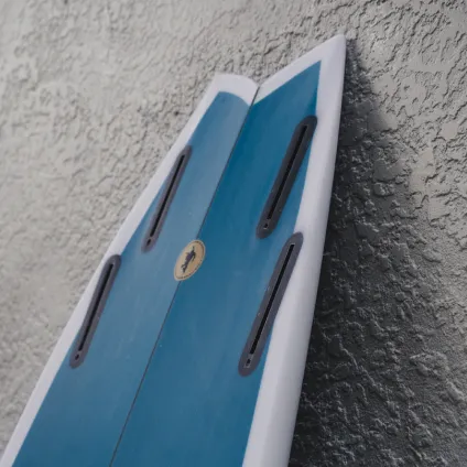 A bespoke Yugen surfboard — hand-shaped tail and fin setup