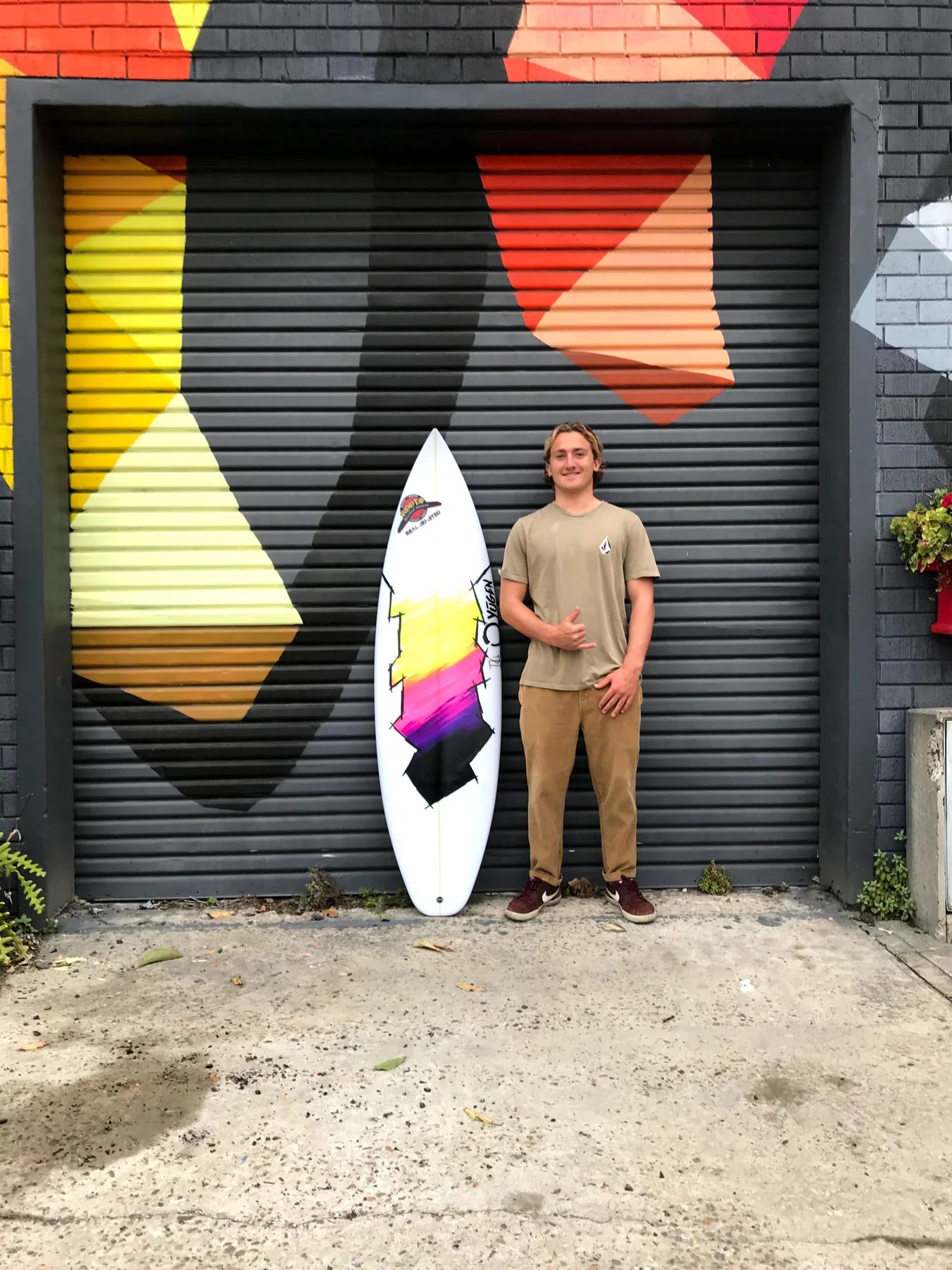Client with a graphic custom Yugen shortboard