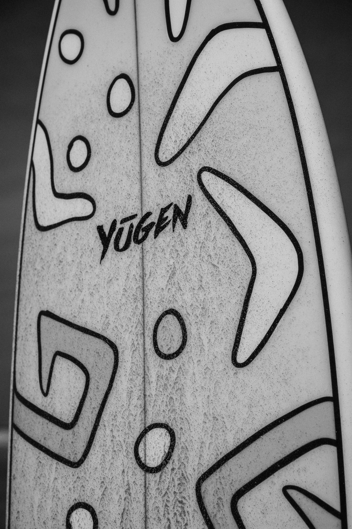 Monochrome artwork detail on a custom Yugen board